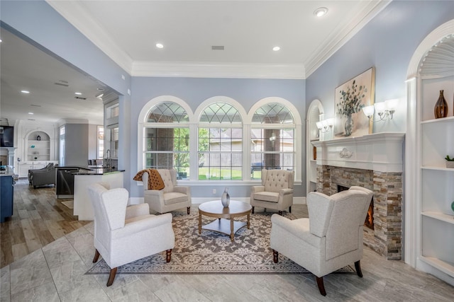 16122 Wimbledon Forest Dr, Spring, TX 77379 - living area featuring a stone fireplace, ornamental molding, built in shelves, baseboards, and recessed lighting