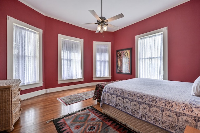bedroom featuring baseboards, a ceiling fan, and wood finished floors