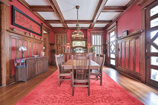 dining room featuring beam ceiling, a wealth of natural light, wood finished floors, and coffered ceiling