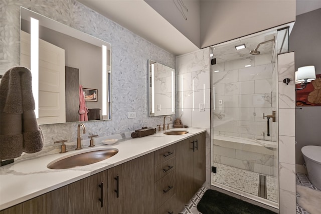 bathroom featuring a sink, a stall shower, and double vanity