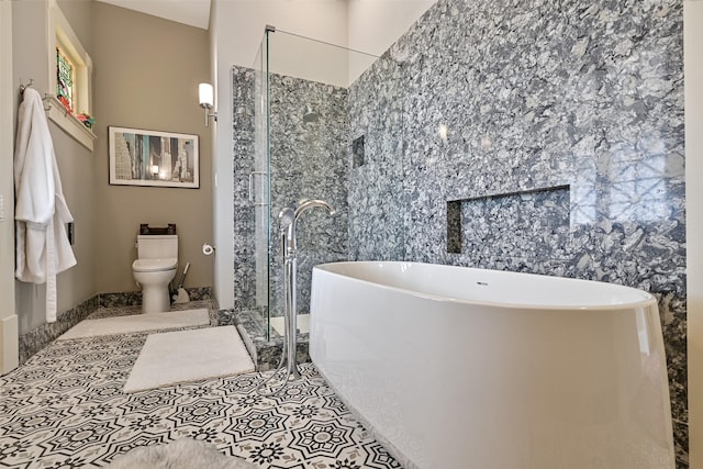 full bath with a freestanding bath, tile patterned flooring, a stall shower, and toilet