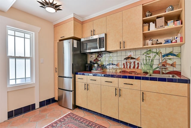 kitchen with light brown cabinetry, appliances with stainless steel finishes, plenty of natural light, and backsplash