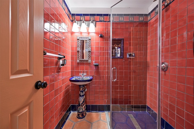 bathroom featuring tile patterned floors and a shower stall