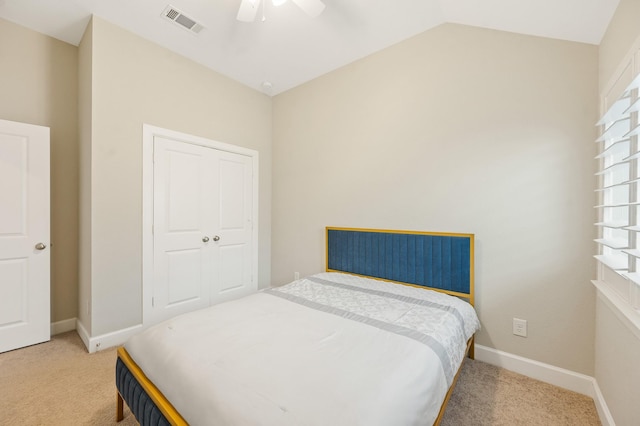bedroom with baseboards, light colored carpet, lofted ceiling, and visible vents