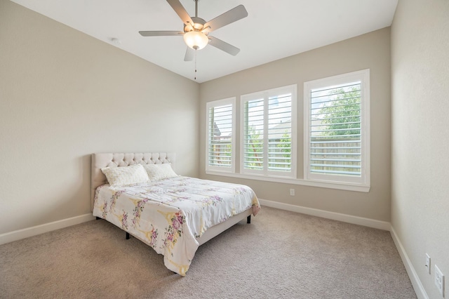 carpeted bedroom with baseboards and ceiling fan