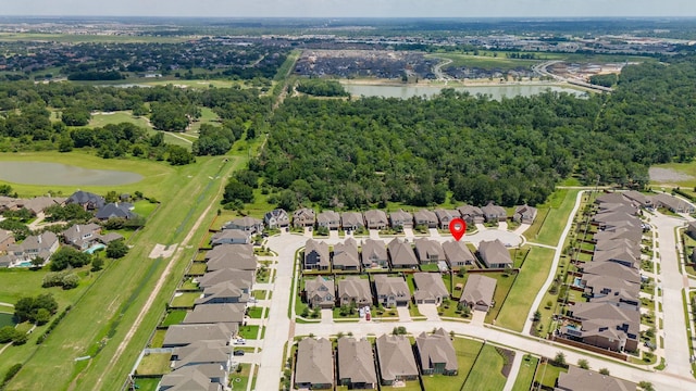 birds eye view of property with a water view and a residential view