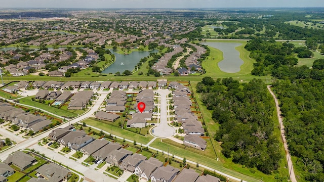 drone / aerial view featuring a water view and a residential view
