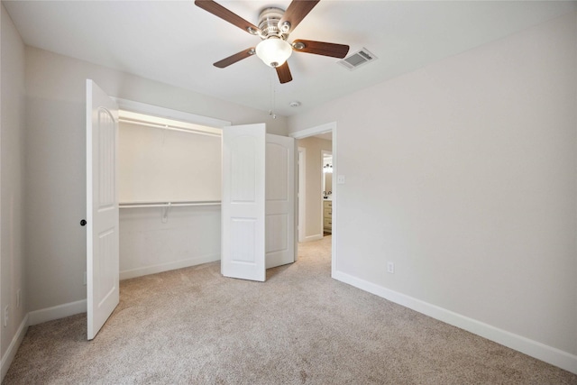 unfurnished bedroom with baseboards, carpet, a closet, and visible vents