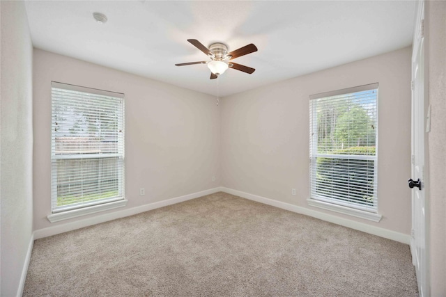 spare room featuring baseboards, a ceiling fan, and carpet flooring