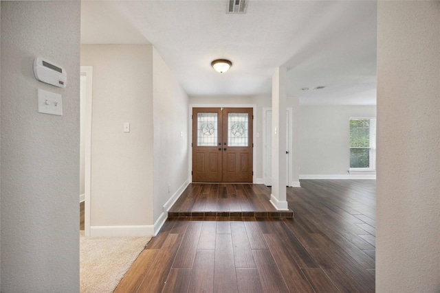 foyer with visible vents, dark wood-style flooring, and baseboards