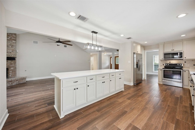 kitchen featuring visible vents, baseboards, ceiling fan, dark wood-style floors, and stainless steel appliances
