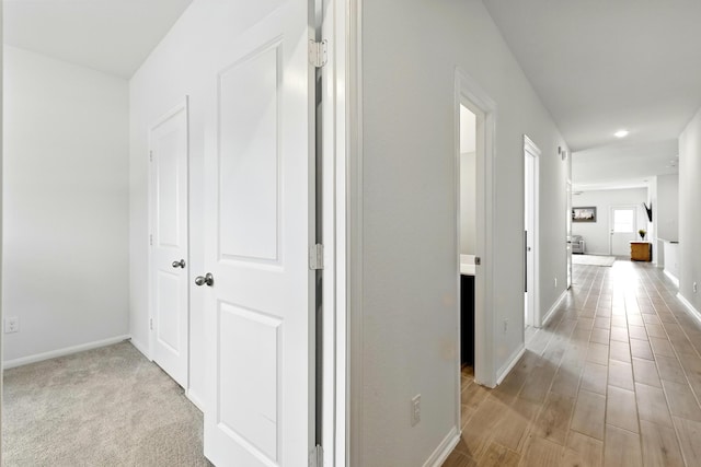 hallway featuring baseboards and recessed lighting