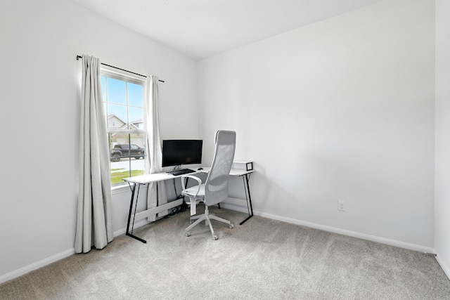 home office featuring carpet floors, baseboards, and a wealth of natural light