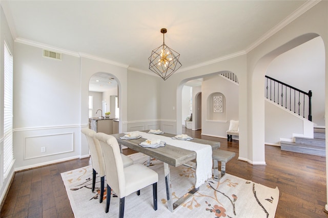 7206 Fountain Mdw, Katy, TX 77494 - dining area featuring crown molding, arched walkways, visible vents, and dark wood finished floors
