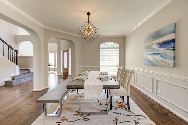 7206 Fountain Mdw, Katy, TX 77494 - dining area featuring crown molding, arched walkways, dark wood-style floors, and stairs