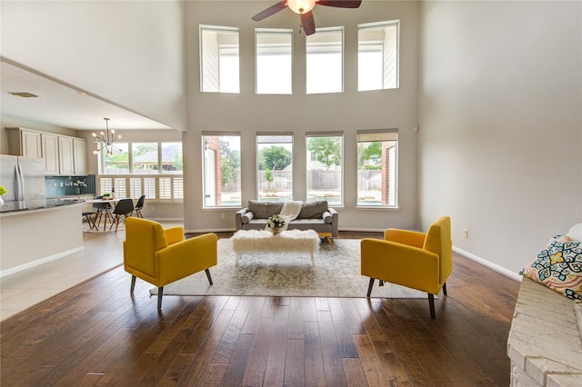 7206 Fountain Mdw, Katy, TX 77494 - living room featuring a towering ceiling, ceiling fan with notable chandelier, and a wealth of natural light