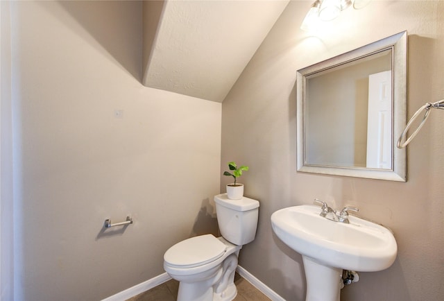 7206 Fountain Mdw, Katy, TX 77494 - half bathroom featuring a sink, tile patterned flooring, toilet, baseboards, and lofted ceiling