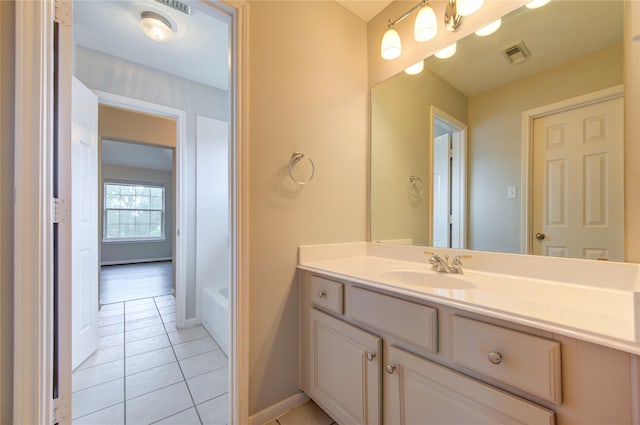 7206 Fountain Mdw, Katy, TX 77494 - bathroom with visible vents, vanity, a washtub, baseboards, and tile patterned floors