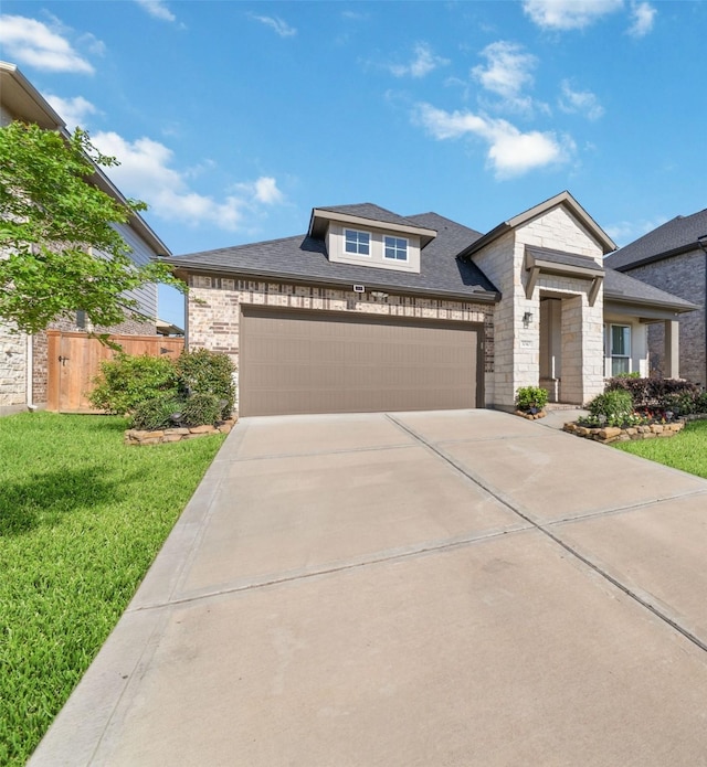 3040 Cirrus Heights Ct, Katy, TX 77493 - view of front of property featuring driveway, stone siding, an attached garage, and a shingled roof