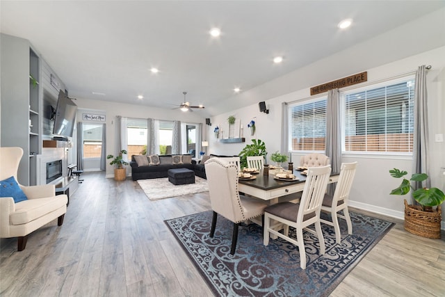 3040 Cirrus Heights Ct, Katy, TX 77493 - dining area with wood finished floors, baseboards, a fireplace, and recessed lighting