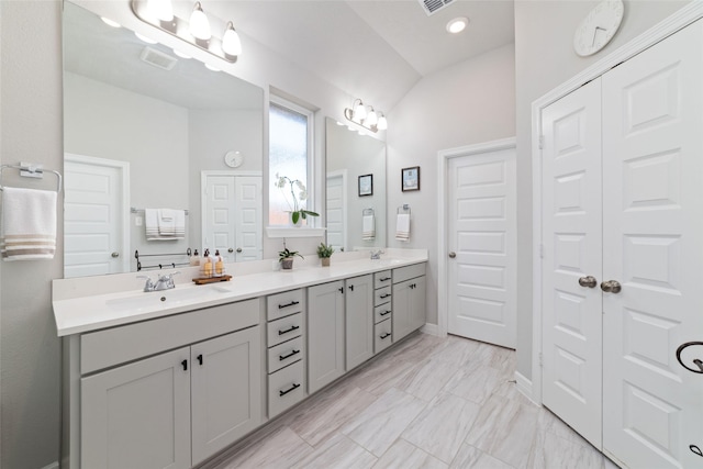 3040 Cirrus Heights Ct, Katy, TX 77493 - bathroom with double vanity, marble finish floors, a closet, and lofted ceiling