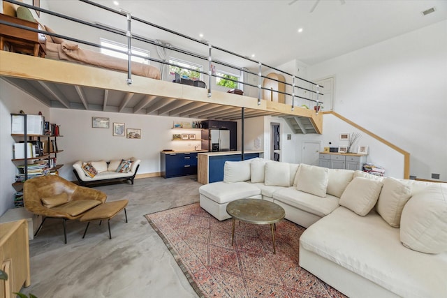 living area featuring finished concrete floors and visible vents