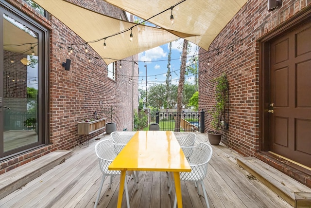 wooden terrace featuring outdoor dining area