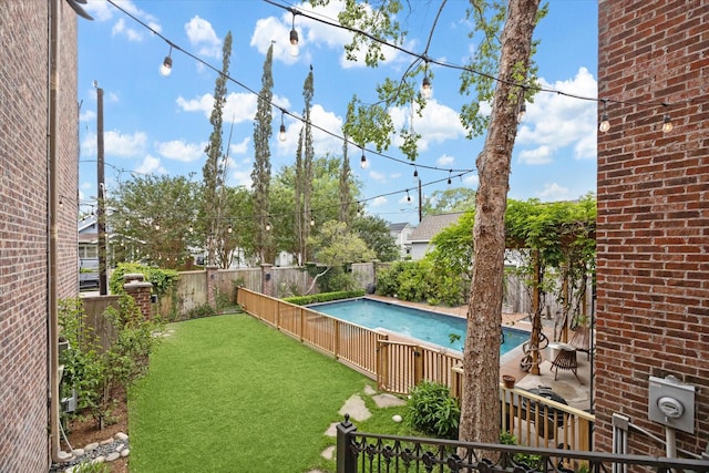 view of swimming pool featuring a fenced backyard, a fenced in pool, and a lawn