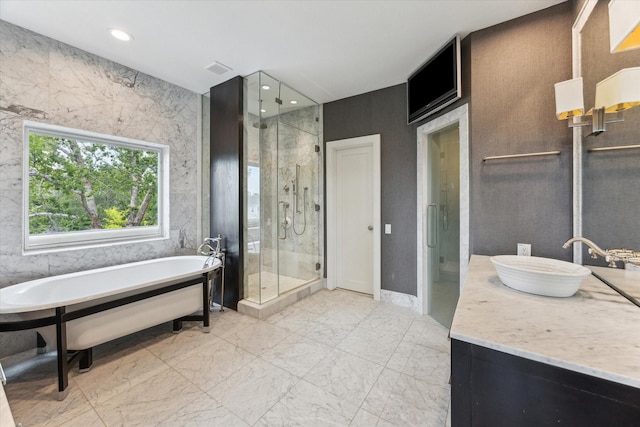 full bath with vanity, marble finish floor, recessed lighting, a soaking tub, and a stall shower