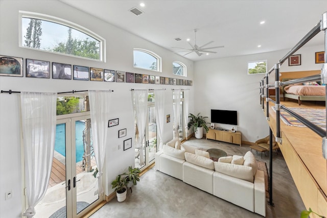 living room with visible vents, finished concrete floors, recessed lighting, french doors, and a ceiling fan