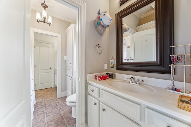 bathroom featuring toilet, ornamental molding, and vanity