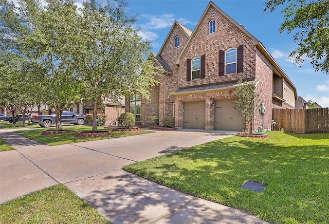 view of front of home featuring fence, an attached garage, brick siding, a front yard, and driveway