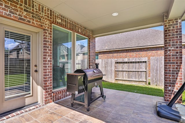 view of patio / terrace with fence and a grill