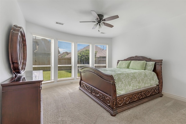 carpeted bedroom with ceiling fan, visible vents, and baseboards
