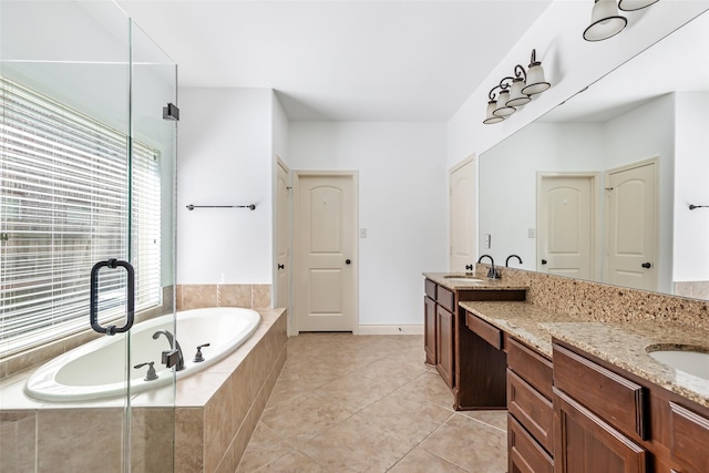 bathroom featuring vanity, tile patterned floors, and a garden tub