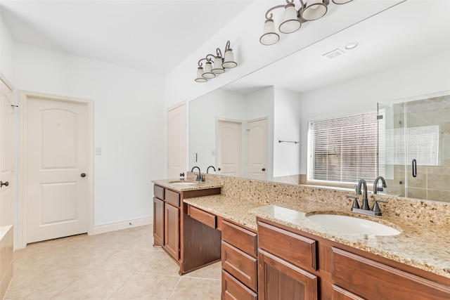 bathroom featuring double vanity, a sink, tile patterned flooring, and a stall shower