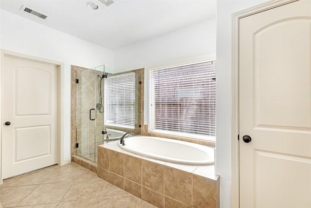 full bathroom featuring visible vents, a stall shower, a bath, and tile patterned flooring