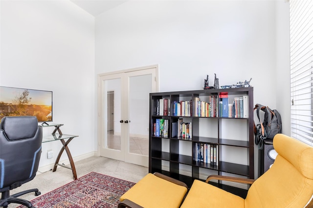 carpeted office featuring baseboards and french doors