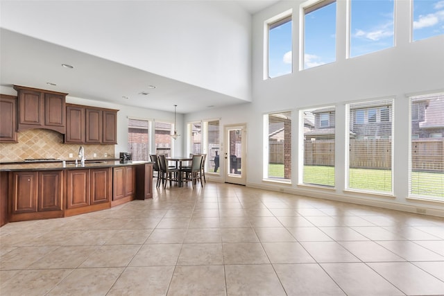 living area with a high ceiling and light tile patterned flooring