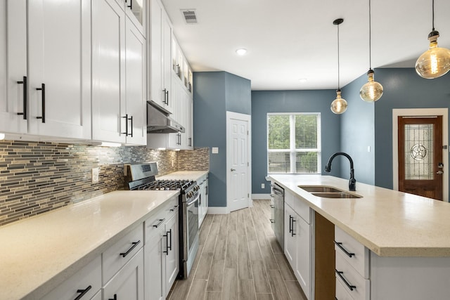 4610 Cashel Glen Dr, Houston, TX 77069 - kitchen with a sink, gas range, decorative backsplash, light wood-type flooring, and under cabinet range hood