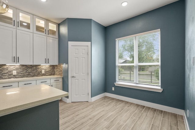 4610 Cashel Glen Dr, Houston, TX 77069 - kitchen with baseboards, recessed lighting, white cabinetry, light wood-style flooring, and backsplash