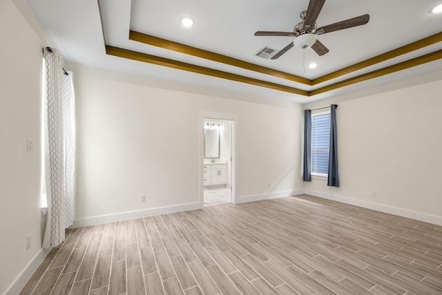 4610 Cashel Glen Dr, Houston, TX 77069 - spare room featuring visible vents, wood finished floors, baseboards, ceiling fan, and a tray ceiling