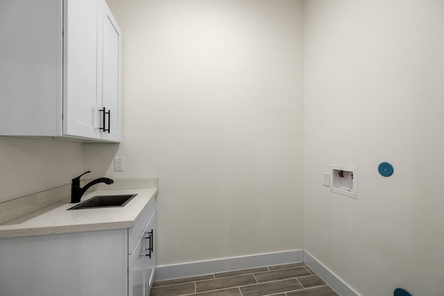 4610 Cashel Glen Dr, Houston, TX 77069 - laundry room with baseboards, a sink, cabinet space, and hookup for a washing machine