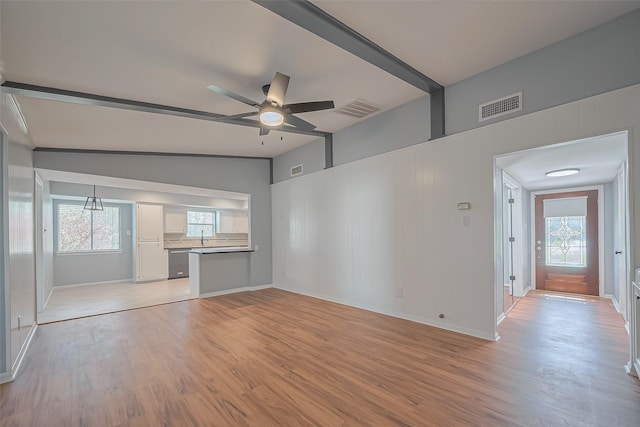 16506 Amcreek Rd, Houston, TX 77068 - unfurnished living room featuring visible vents, a ceiling fan, light wood-style flooring, and a healthy amount of sunlight