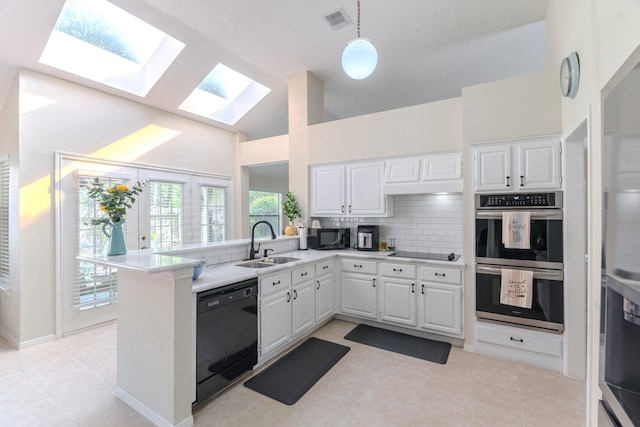 3511 Lost Oak Dr, Spring, TX 77388 - kitchen with a sink, light countertops, backsplash, a skylight, and black appliances