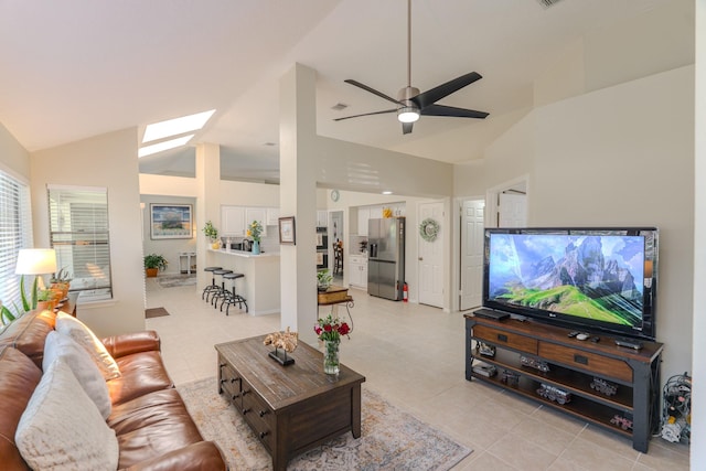 3511 Lost Oak Dr, Spring, TX 77388 - living area featuring ceiling fan, light tile patterned floors, a skylight, and high vaulted ceiling