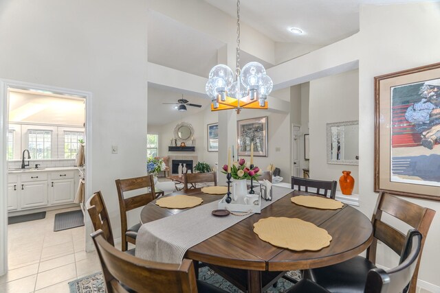 3511 Lost Oak Dr, Spring, TX 77388 - dining room with light tile patterned floors, a high ceiling, a fireplace, and ceiling fan with notable chandelier
