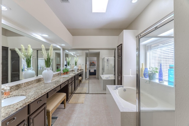 3511 Lost Oak Dr, Spring, TX 77388 - bathroom with a sink, tile patterned flooring, double vanity, a shower stall, and a garden tub