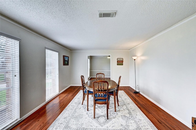 dining room featuring visible vents, a textured ceiling, and a wealth of natural light
