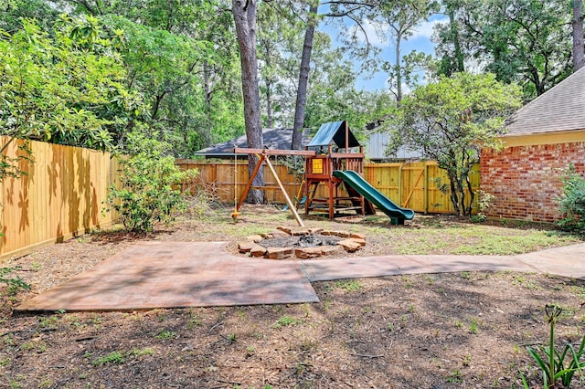 view of play area with a patio and a fenced backyard
